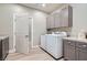 Bright laundry room with washer, dryer and cabinets at 8068 Buena Vida St, Las Vegas, NV 89166
