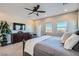 Main bedroom with large windows, a ceiling fan and a dresser at 8068 Buena Vida St, Las Vegas, NV 89166