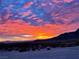 Vibrant sunset with colorful clouds over the mountains at 8068 Buena Vida St, Las Vegas, NV 89166