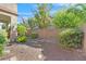 Landscaped backyard with gravel, stone pathway, and desert plants at 8212 Opal Falls St, North Las Vegas, NV 89085
