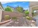 Small backyard with gravel and drought-tolerant plants at 8212 Opal Falls St, North Las Vegas, NV 89085