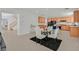 Bright dining area with a glass table and four chairs next to the kitchen at 8212 Opal Falls St, North Las Vegas, NV 89085