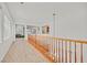 Upstairs hallway with wooden railing and light hardwood floors at 8212 Opal Falls St, North Las Vegas, NV 89085