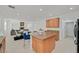 Kitchen island, light wood cabinets and view into living room at 8212 Opal Falls St, North Las Vegas, NV 89085