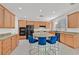 Spacious kitchen with light wood cabinets, granite countertops and an island at 8212 Opal Falls St, North Las Vegas, NV 89085