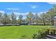 Large green lawn with mature trees and distant view at 8212 Opal Falls St, North Las Vegas, NV 89085