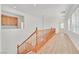 Bright upper landing with wood stairs and flooring, and built-in cabinets at 8212 Opal Falls St, North Las Vegas, NV 89085