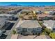 Aerial view of a townhome community showing multiple units with tile roofs and a street view at 8486 Insignia Ave # 101, Las Vegas, NV 89178