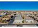 Aerial view of a townhome community with multiple units, landscaping, and mountain views in the background at 8486 Insignia Ave # 101, Las Vegas, NV 89178