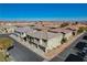 Aerial view of a townhome community with various units, roads, and a distant city view at 8486 Insignia Ave # 101, Las Vegas, NV 89178