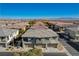 Aerial view of a two-story townhome with attached garage and surrounding community at 8486 Insignia Ave # 101, Las Vegas, NV 89178