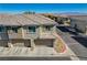 Aerial view of a townhome with a two-car attached garage and landscaping at 8486 Insignia Ave # 101, Las Vegas, NV 89178