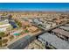 Aerial view of community pool, homes, and surrounding area at 8486 Insignia Ave # 101, Las Vegas, NV 89178