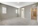 Spacious bedroom with carpet flooring and ensuite bathroom access at 8486 Insignia Ave # 101, Las Vegas, NV 89178