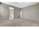 Primary bedroom with carpet flooring and access to the bathroom and hallway at 8486 Insignia Ave # 101, Las Vegas, NV 89178