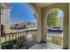 Front porch with arched entryway, wrought iron railings, and a view of the neighborhood at 8486 Insignia Ave # 101, Las Vegas, NV 89178