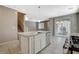 Modern kitchen with island, stainless steel appliances and granite countertops at 8486 Insignia Ave # 101, Las Vegas, NV 89178