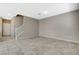 Neutral-toned living room with tile floors and a staircase at 8486 Insignia Ave # 101, Las Vegas, NV 89178