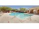 Community pool with plenty of lounge chairs and covered seating at 8486 Insignia Ave # 101, Las Vegas, NV 89178