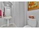 Small powder room with pedestal sink and toilet at 9032 Park Forest Ct, Las Vegas, NV 89134