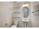 Small bathroom with pedestal sink and shelving at 10079 S Riley St, Las Vegas, NV 89178