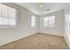 Well-lit bedroom featuring neutral walls and carpet floors at 10079 S Riley St, Las Vegas, NV 89178