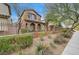 Two-story house with front yard landscaping and a brown fence at 10079 S Riley St, Las Vegas, NV 89178