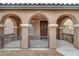 Covered entryway with arched columns and a wooden door at 10079 S Riley St, Las Vegas, NV 89178