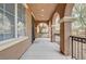 Covered porch with tiled flooring and a security screen door at 10079 S Riley St, Las Vegas, NV 89178