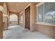 Covered porch with tiled flooring and a security screen door at 10079 S Riley St, Las Vegas, NV 89178