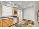 Eat-in kitchen with wood cabinets and sliding glass door at 10079 S Riley St, Las Vegas, NV 89178