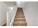 Carpeted staircase with white railing at 10079 S Riley St, Las Vegas, NV 89178