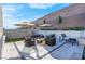 Relaxing backyard patio with seating area, fire pit, and modern umbrellas at 11903 Sandstone Arch Dr, Las Vegas, NV 89138