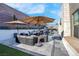 Modern backyard oasis with a pool, patio furniture, and umbrellas at 11903 Sandstone Arch Dr, Las Vegas, NV 89138