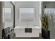 Soaking tub with modern fixtures and large mirror at 11903 Sandstone Arch Dr, Las Vegas, NV 89138