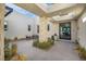 Private courtyard entry with seating and lush landscaping at 11903 Sandstone Arch Dr, Las Vegas, NV 89138