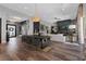 Modern dining room with dark wood table and black chairs, open to living room at 11903 Sandstone Arch Dr, Las Vegas, NV 89138