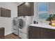 Laundry room with modern washer, dryer, and cabinets at 11903 Sandstone Arch Dr, Las Vegas, NV 89138