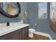 Elegant powder room with a modern vanity and blue walls at 11903 Sandstone Arch Dr, Las Vegas, NV 89138