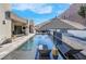 Relaxing pool with lounge chairs and patio umbrellas at 11903 Sandstone Arch Dr, Las Vegas, NV 89138