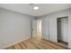 Well-lit bedroom with wood floors, a closet, and access to another room at 1208 Marion Dr, Las Vegas, NV 89110