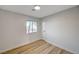 Bright bedroom with light grey walls and wood-look floors at 1208 Marion Dr, Las Vegas, NV 89110