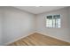 Bright bedroom with wood-look floors and a window offering natural light at 1208 Marion Dr, Las Vegas, NV 89110