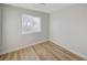 Bright bedroom with light grey walls and wood-look floors at 1208 Marion Dr, Las Vegas, NV 89110