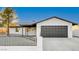 Remodeled single story home with modern gray garage door and new landscaping at 1208 Marion Dr, Las Vegas, NV 89110