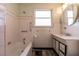 White tiled bathroom with bathtub and vanity at 1229 S 9Th St, Las Vegas, NV 89104