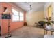 Bright dining room with peach walls, carpet, and large windows at 1229 S 9Th St, Las Vegas, NV 89104