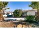 Front yard with palm trees and a gravel driveway at 1229 S 9Th St, Las Vegas, NV 89104