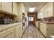 Long kitchen with light cabinets and laminate floor at 1229 S 9Th St, Las Vegas, NV 89104