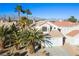 Two-story house with tile roof and attached garage, mountain backdrop at 1608 Council Bluff Ln, North Las Vegas, NV 89031